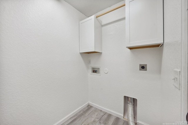 laundry room with electric dryer hookup, cabinets, gas dryer hookup, hookup for a washing machine, and light hardwood / wood-style floors