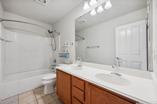 full bathroom featuring vanity, tile patterned floors, washtub / shower combination, toilet, and a textured ceiling