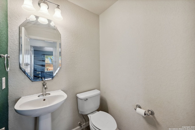 bathroom featuring toilet and sink