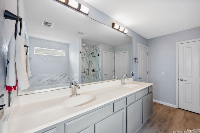 bathroom with vanity, wood-type flooring, and walk in shower