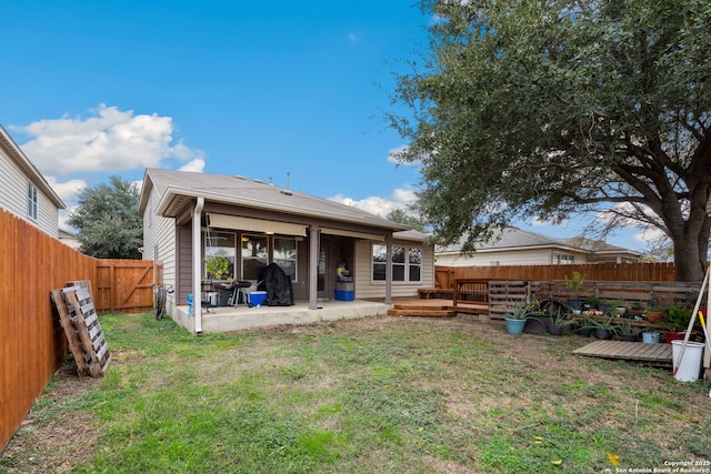 rear view of house featuring a patio area and a yard