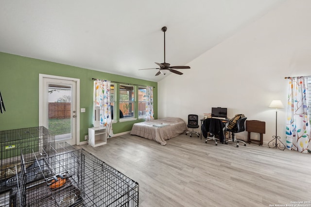 bedroom featuring light hardwood / wood-style floors, vaulted ceiling, and ceiling fan