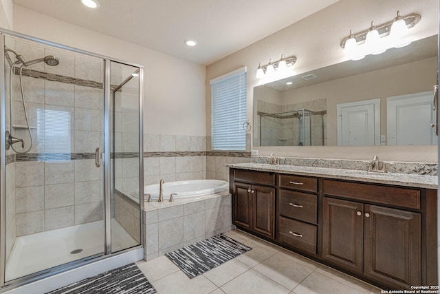 bathroom with shower with separate bathtub, vanity, and tile patterned floors