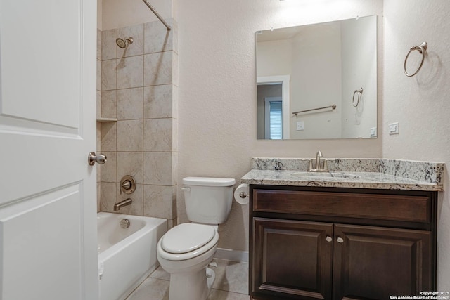 full bathroom with toilet, tile patterned flooring, vanity, and tiled shower / bath