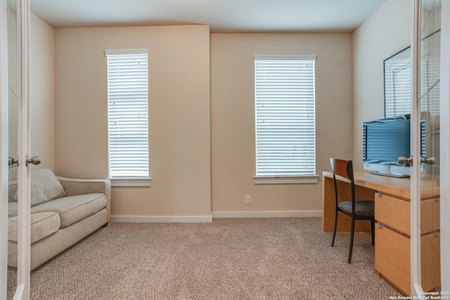 office with plenty of natural light and light colored carpet