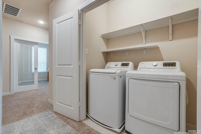 washroom featuring independent washer and dryer and light carpet