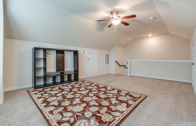 living room with carpet flooring, ceiling fan, and lofted ceiling