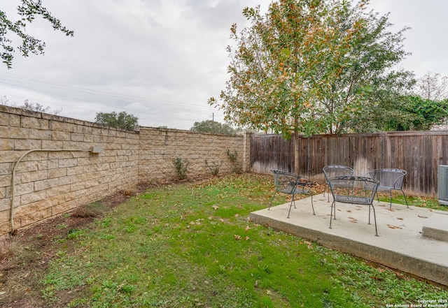 view of yard with cooling unit and a patio area