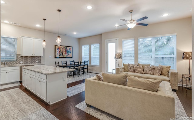 living room featuring dark hardwood / wood-style floors and ceiling fan