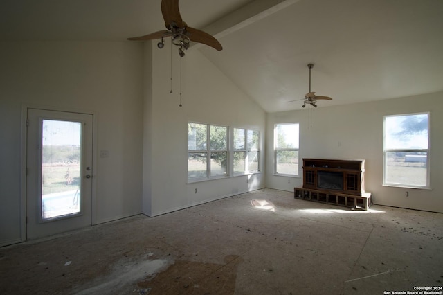 unfurnished living room with ceiling fan, beam ceiling, and high vaulted ceiling