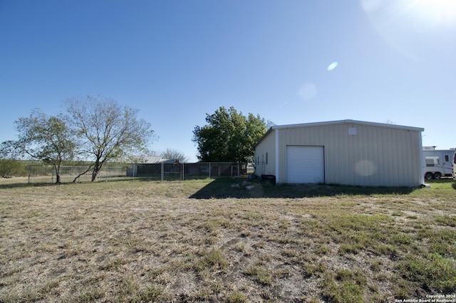 view of yard with a garage and an outdoor structure