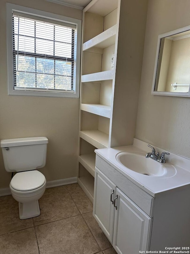 bathroom with tile patterned flooring, vanity, and toilet