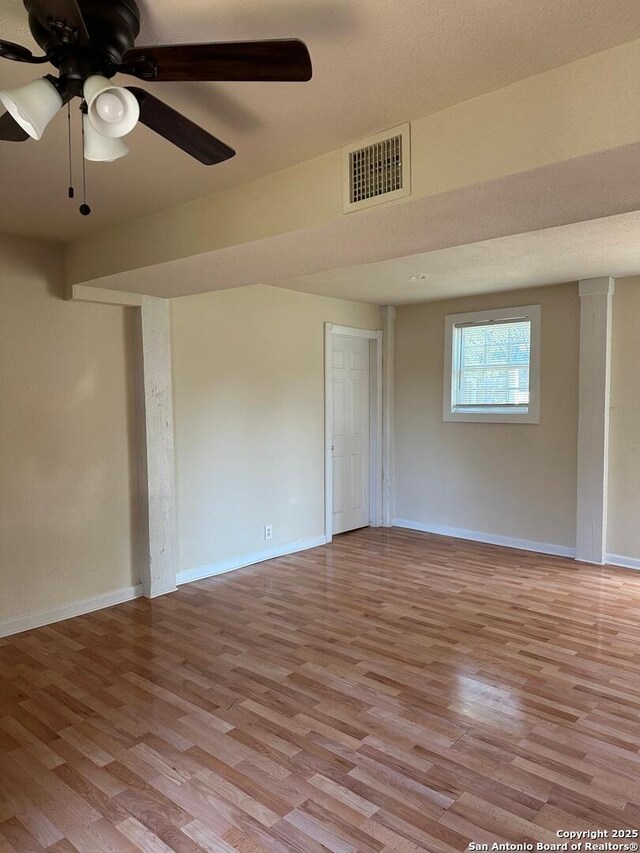 spare room featuring light hardwood / wood-style floors and ceiling fan