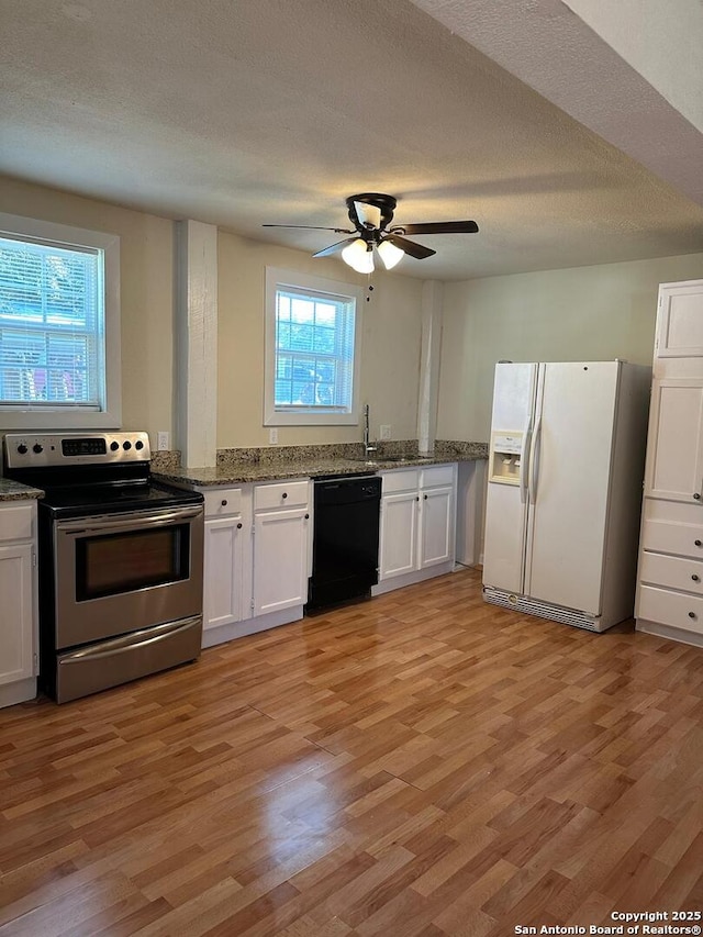 kitchen featuring white cabinets, dishwasher, white refrigerator with ice dispenser, and stainless steel range with electric cooktop