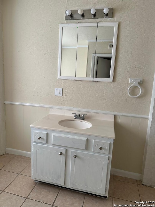 bathroom with tile patterned flooring and vanity