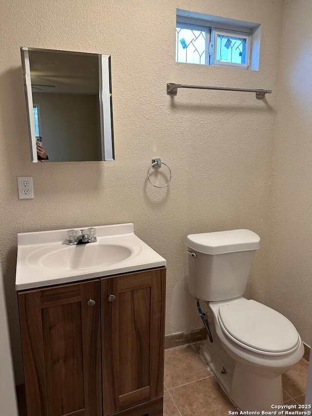 bathroom with tile patterned floors, vanity, and toilet