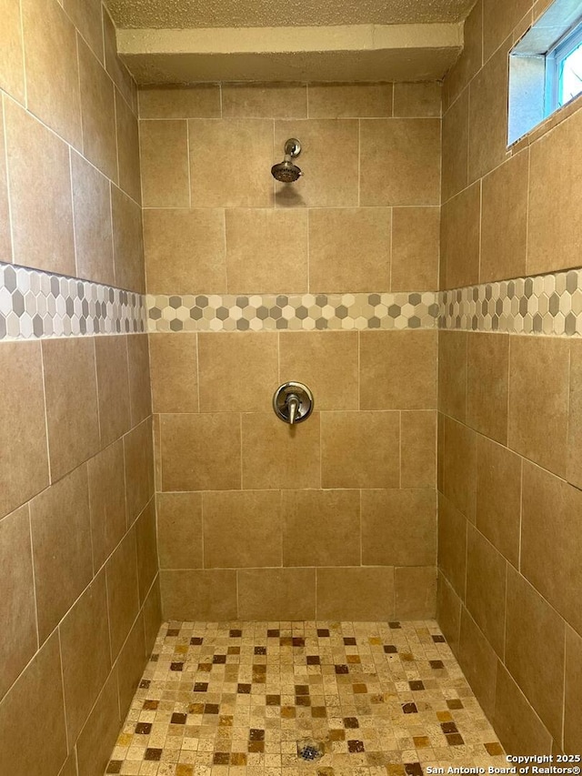 bathroom with a tile shower