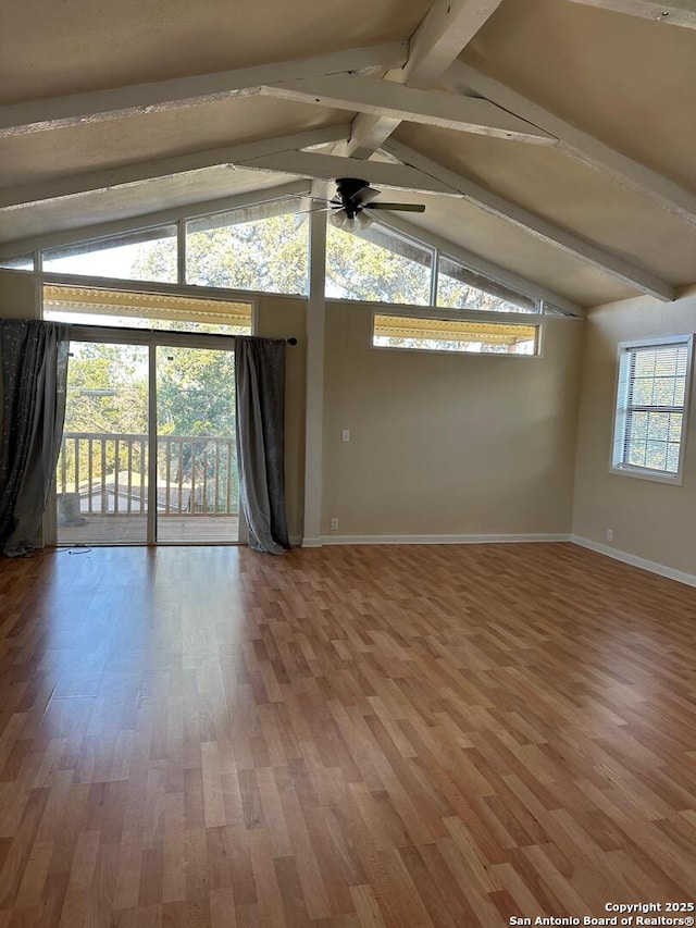 spare room featuring hardwood / wood-style flooring, vaulted ceiling with beams, and ceiling fan