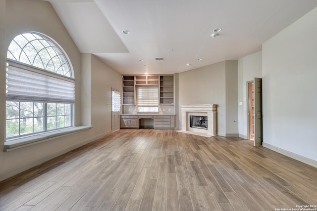 unfurnished living room featuring light hardwood / wood-style floors and a premium fireplace