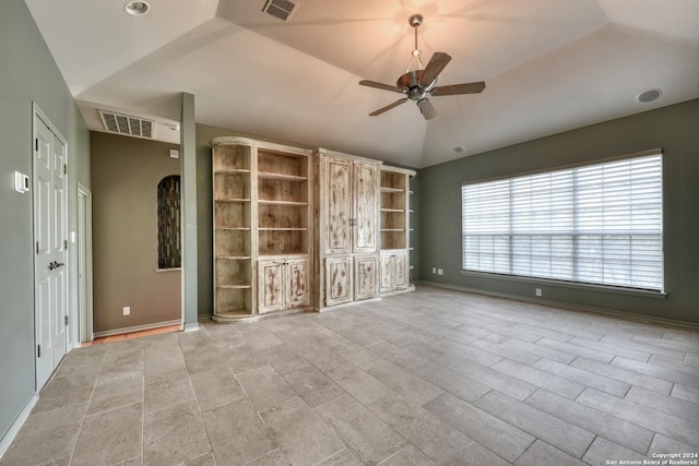 unfurnished living room with ceiling fan and lofted ceiling