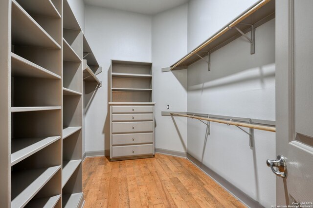 spacious closet with light hardwood / wood-style floors