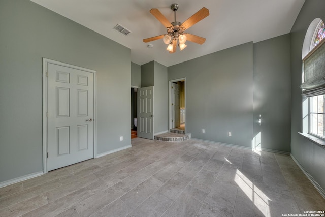 unfurnished bedroom with ensuite bath and ceiling fan