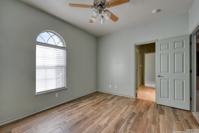 spare room featuring light hardwood / wood-style flooring and ceiling fan