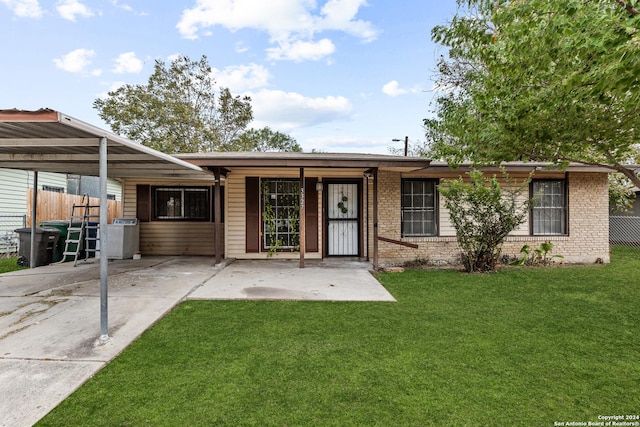 single story home featuring a front lawn and a carport