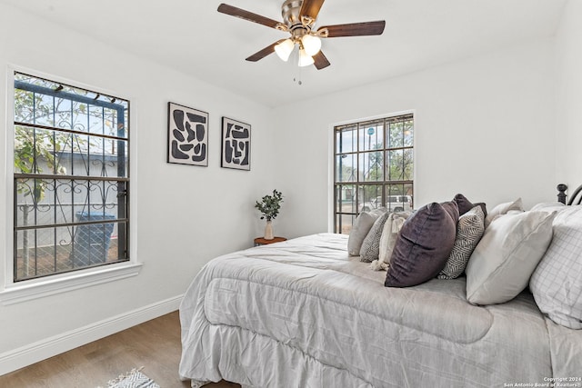 bedroom with ceiling fan and hardwood / wood-style flooring