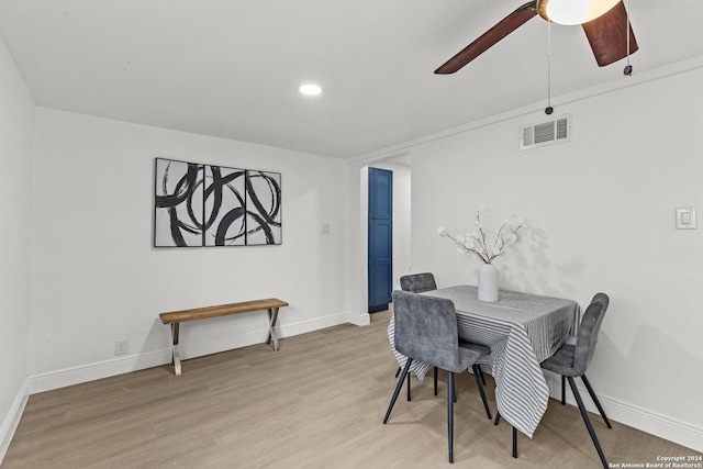 dining space with ceiling fan and light hardwood / wood-style flooring