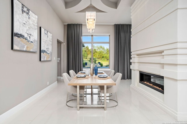 dining area with coffered ceiling, light tile patterned floors, and a chandelier