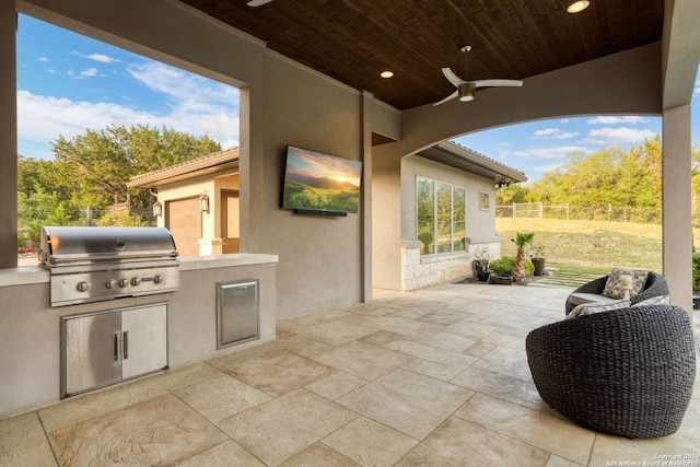 view of patio featuring ceiling fan, area for grilling, and grilling area