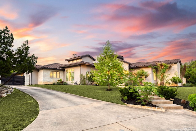 mediterranean / spanish-style house featuring a lawn