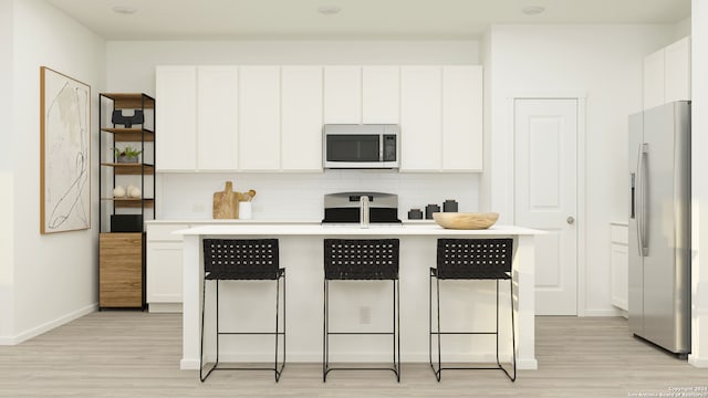 kitchen with stove, backsplash, light hardwood / wood-style flooring, stainless steel fridge with ice dispenser, and white cabinetry