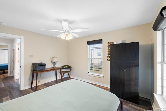 bedroom with dark hardwood / wood-style floors and ceiling fan