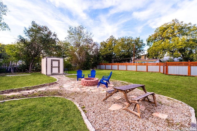 view of yard with an outdoor fire pit and a storage shed