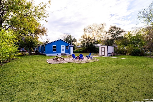 view of yard featuring a fire pit and a shed