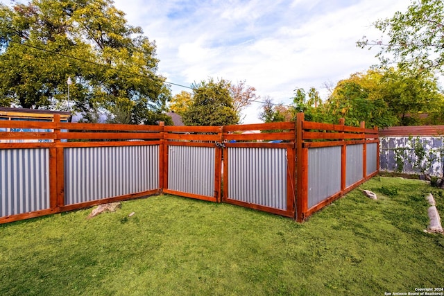 view of gate featuring a yard