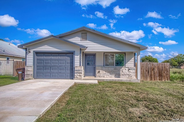 view of front of house with a front yard and a garage