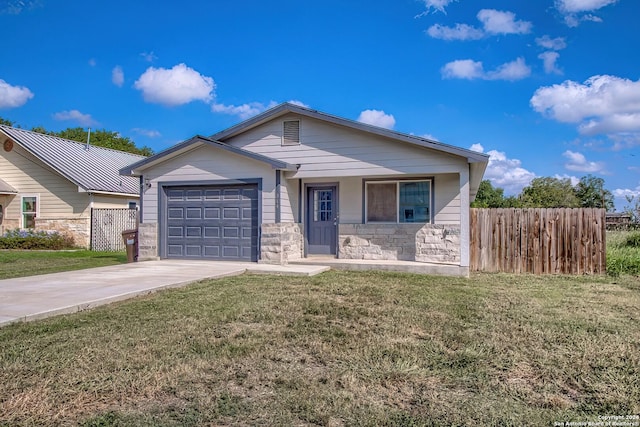 view of front of property featuring a front lawn and a garage