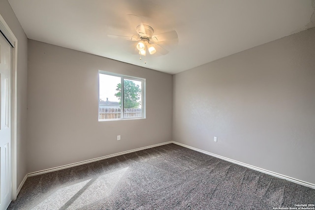 empty room with ceiling fan and carpet