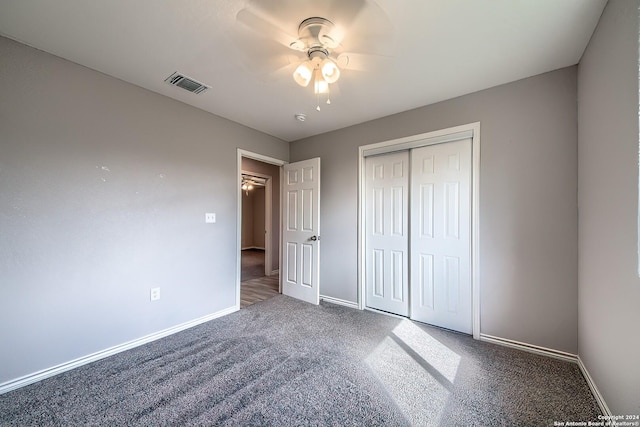 unfurnished bedroom featuring carpet flooring, ceiling fan, and a closet