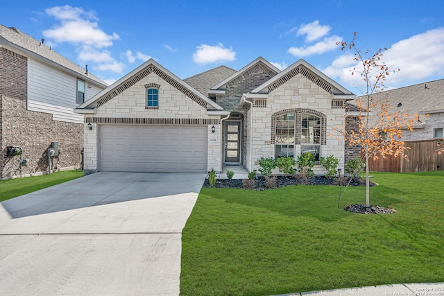 view of front of property featuring a garage and a front lawn