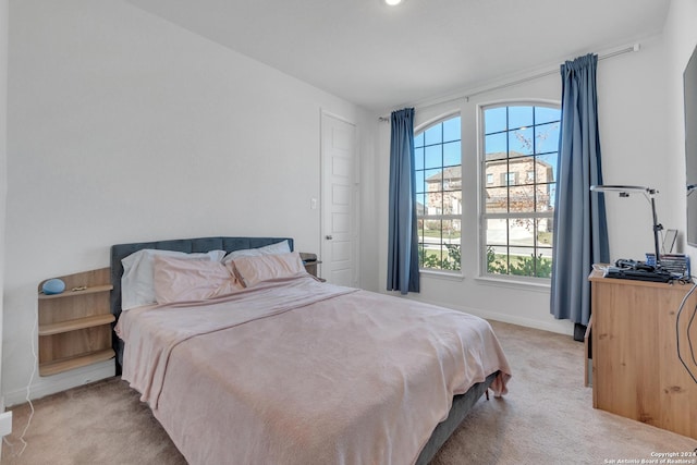 bedroom with light colored carpet