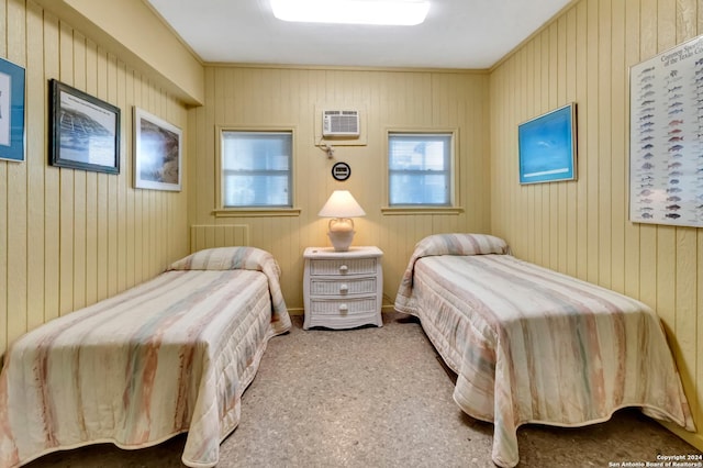 bedroom with carpet floors and a wall unit AC