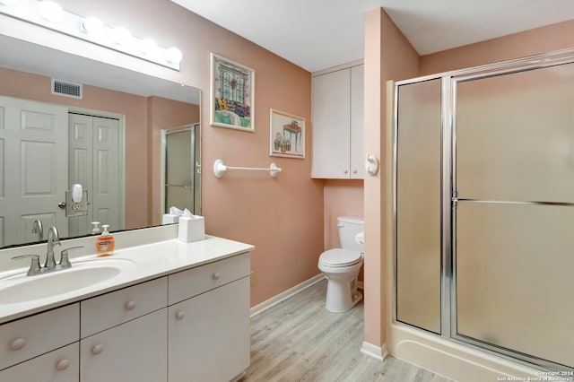 bathroom with vanity, wood-type flooring, and walk in shower