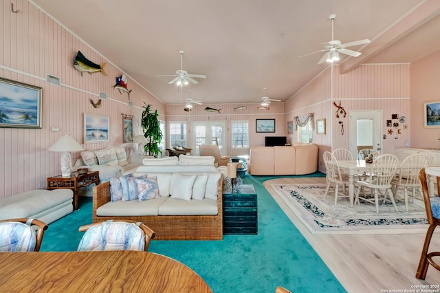 living room with hardwood / wood-style flooring, crown molding, and lofted ceiling