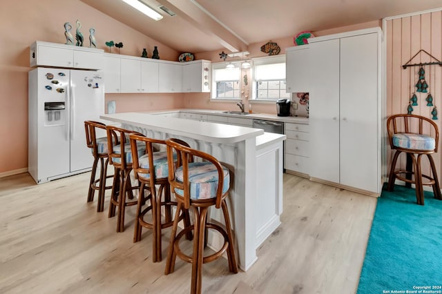 kitchen featuring sink, white refrigerator with ice dispenser, light hardwood / wood-style flooring, white cabinets, and a kitchen island