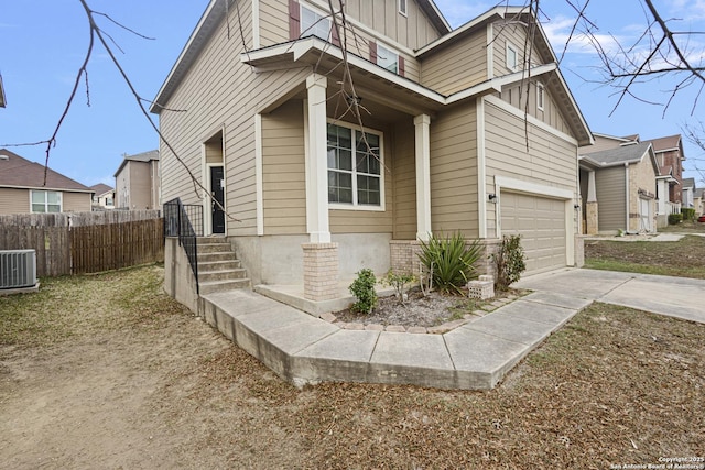 view of front of house with central AC and a garage