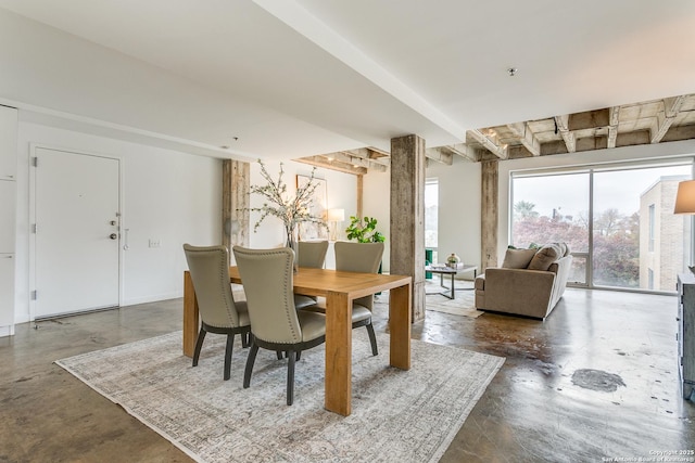 dining space featuring concrete flooring